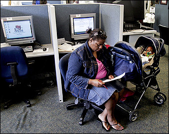 Stefanie McCall-Spencer, with her 6-month-old son Coleman, works on her résumé at a career center in Raleigh, N.C. Economists forecast that unemployment will rise through the end of the year and could extend well into 2010.